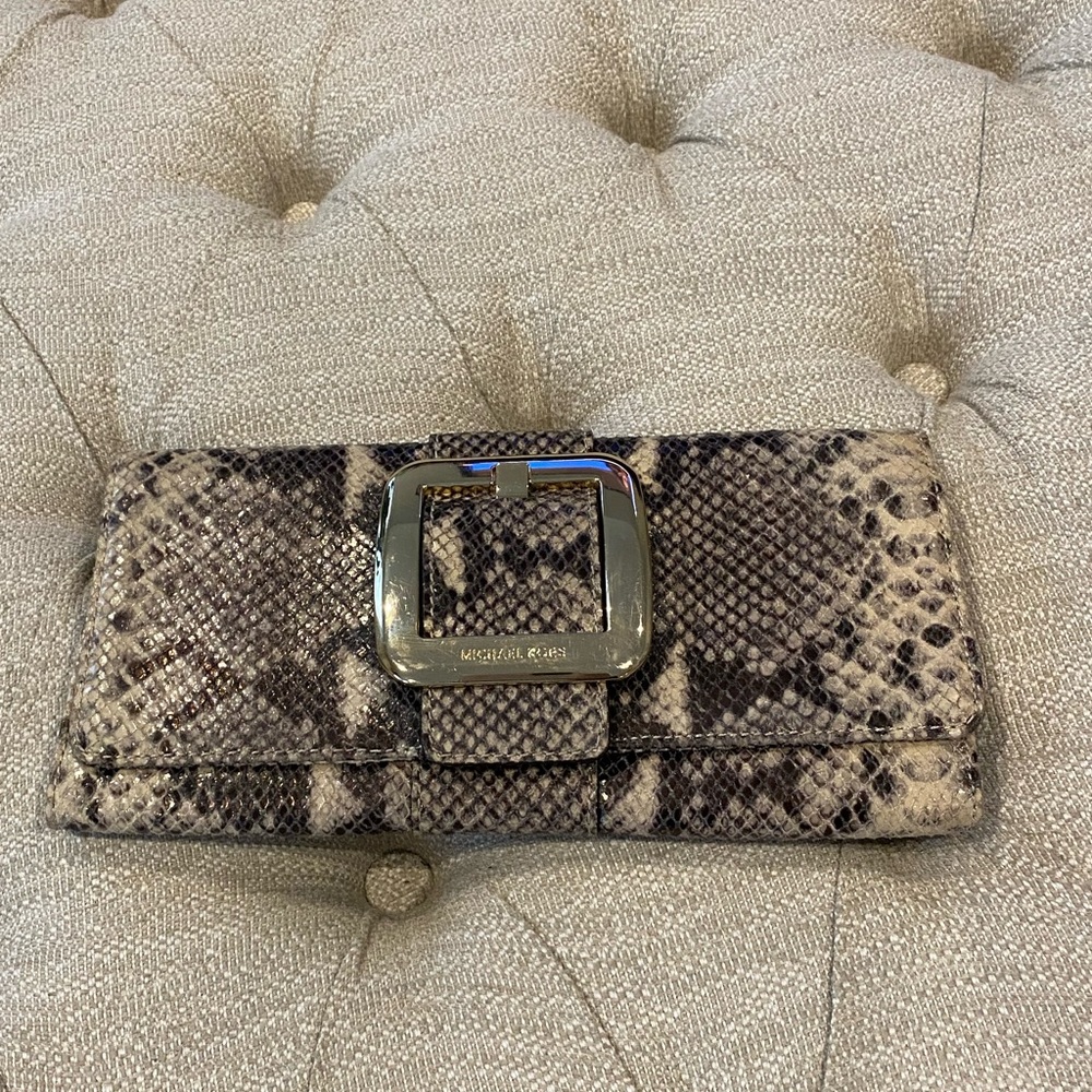 Michael Kors Snake Skin clutch with gold buckle & magnetic button closure.